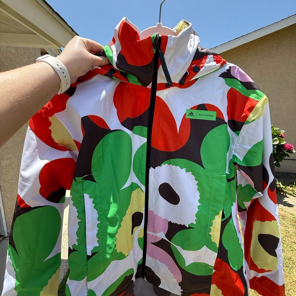 Adidas Marimekko windbreaker, never worn. Features removable hood. Size S
